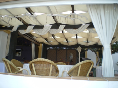 Copyright image: An beautiful attached lean-to pergola used for outdoor dining, overlooking the sea.
