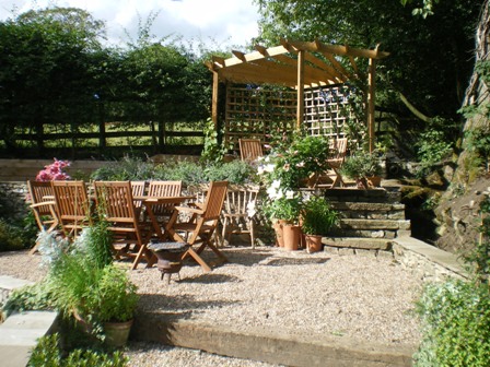 Copyright image: A wonderful corner pergola design in a romantic cottage garden. 