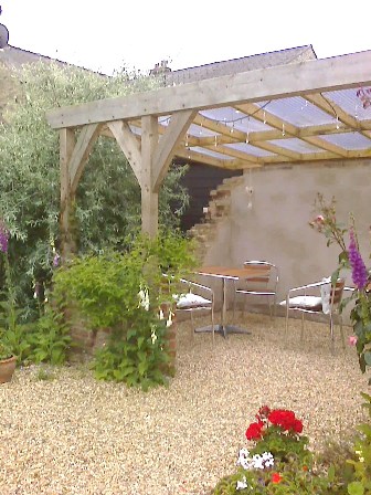 Copyright image: Attached lean-to pergola with climbing plants.