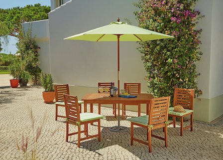 Wooden garden furniture with green parasol.