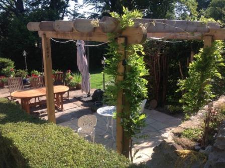 Copyright image: Curved style rafters set off this pergola made from the free pergola plans.