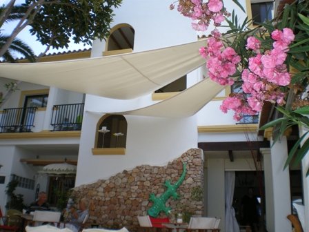 Copyright image: Shade sails secured to an attached lean-to pergola.