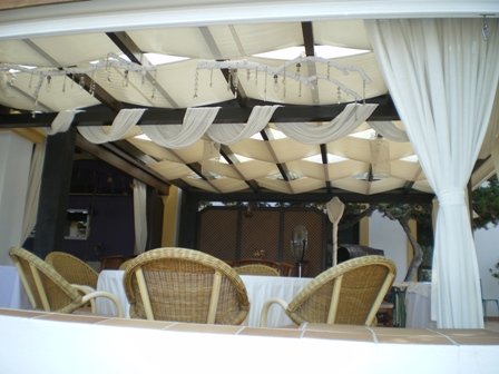 Copyright image: Beautiful pergola with canopy drapes.