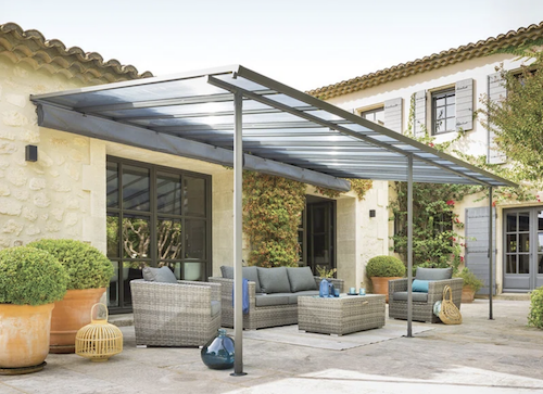 Metal lean-to pergola kit with retractable canopy.