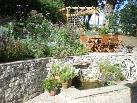 Copyright image: Pergola romance:  A gorgeous cottage garden with pergola and water feature.