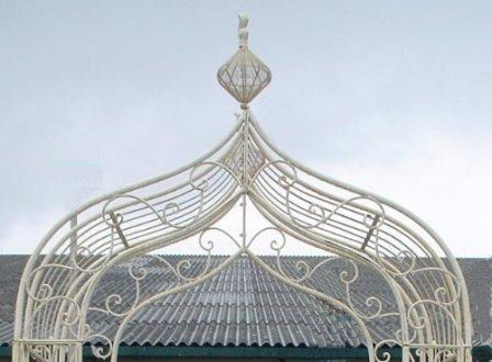 Intricate metal rose arch in cream.