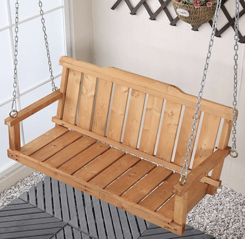 Wooden weatherproof swing bench for a pergola.
