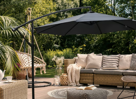Grey garden parasol with beautiful garden furniture.