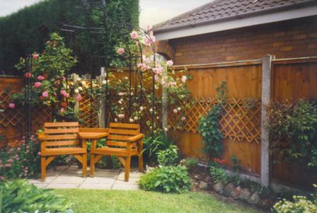 Copyright image: Garden makeover - a rose-covered gazebo with garden seat. 