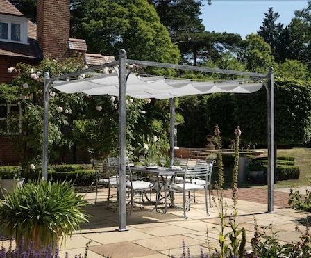 Gorgeous metal pergola with retractable canopy over a beautiful metal dining set.