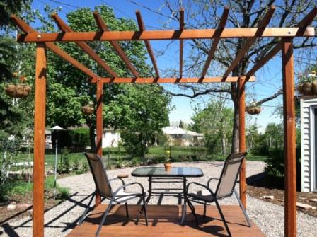 Copyright image: Pergola with added deck made from the free pergola plans.
