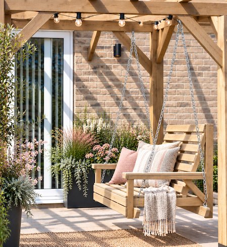 Copyright image: A fantastic attached lean-to pergola with hanging seat.