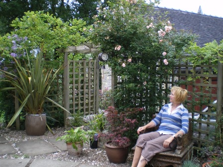 Copyright image: Pergola design made from the free pergola plans, the rafters draped in beautiful climbing plants.